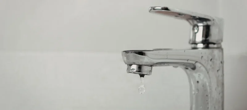 bathroom faucet dripping indicating a plumbing issue.
