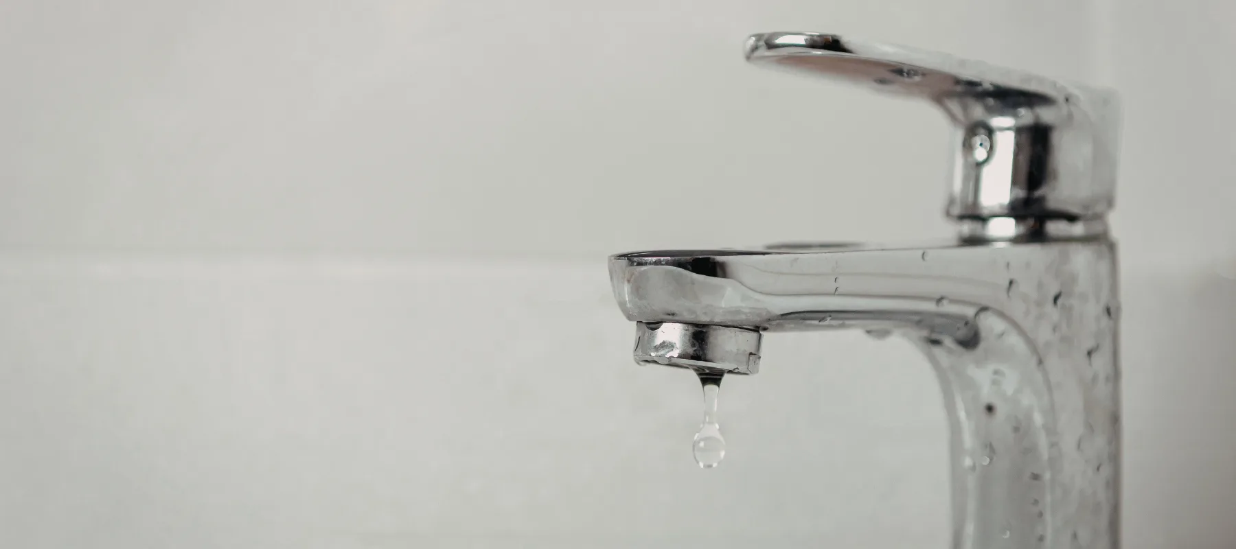 bathroom faucet dripping indicating a plumbing issue.